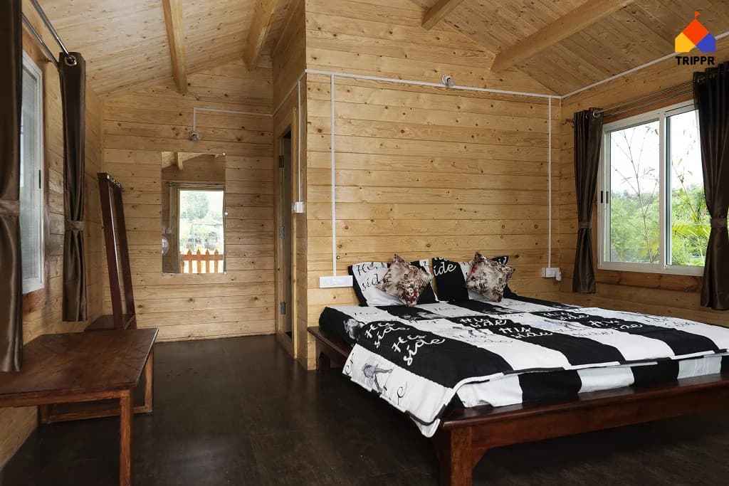Wood-panelled cottage bedroom at Trippr Chikkamagaluru