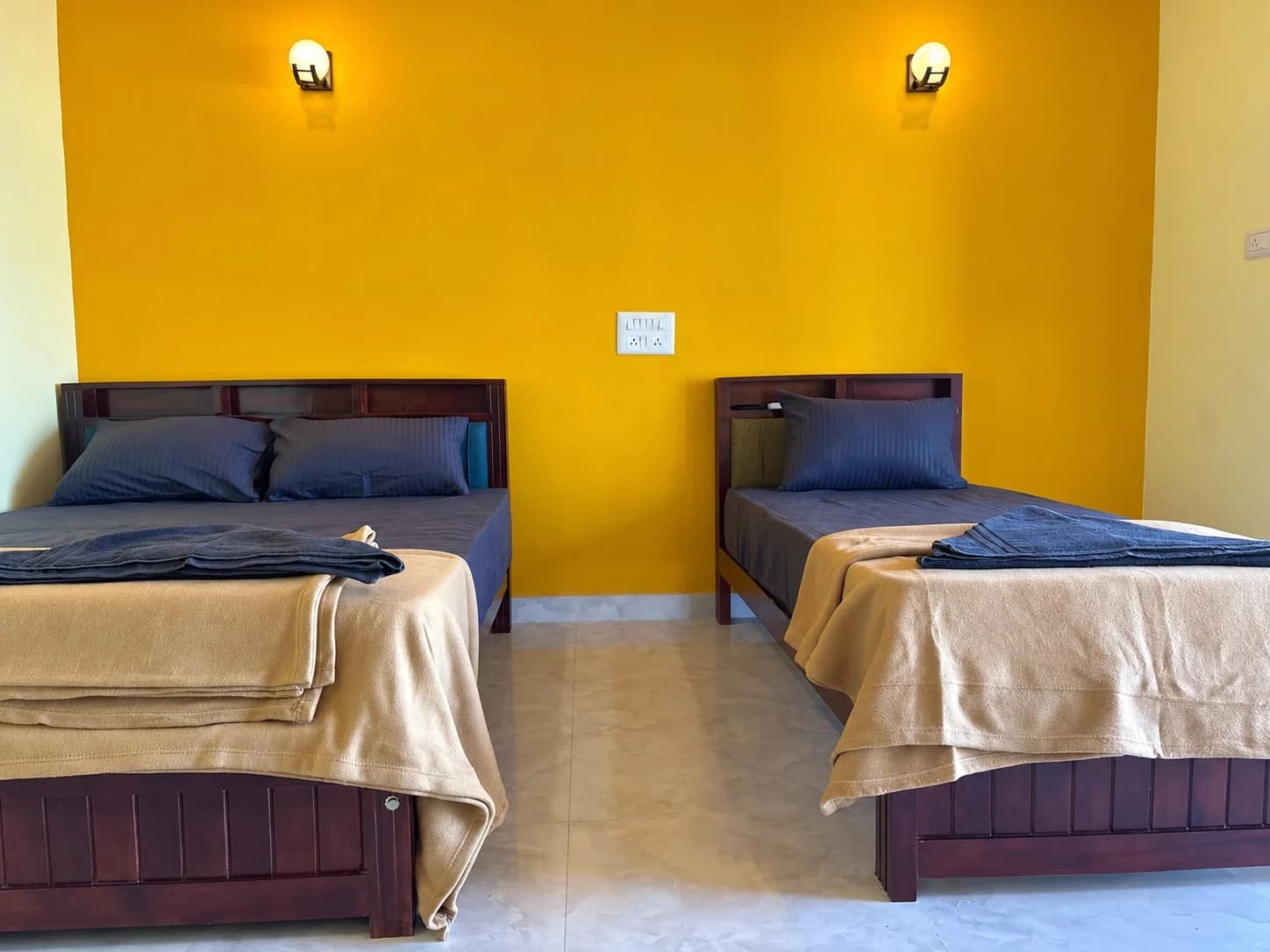 Family room with a double and single bed at Famstel Gokarna