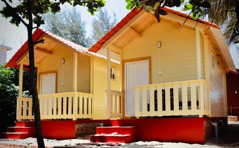 Wooden cottage with a shaded veranda at Famstel Gokarna