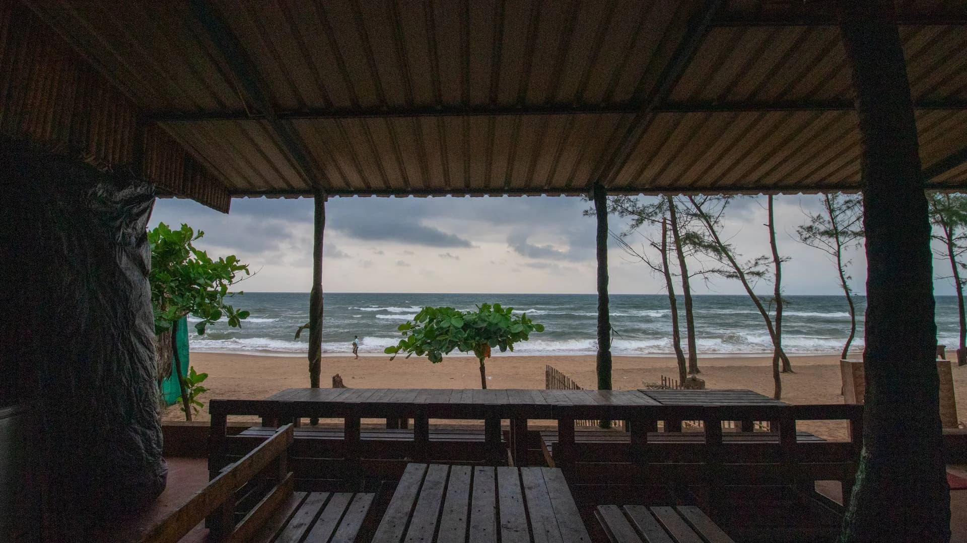 Shaded seating facing the beach at Trippr Gokarna