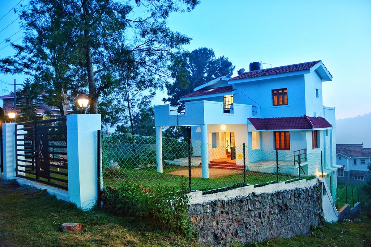 Trippr Kodaikanal illuminated at dusk among the trees