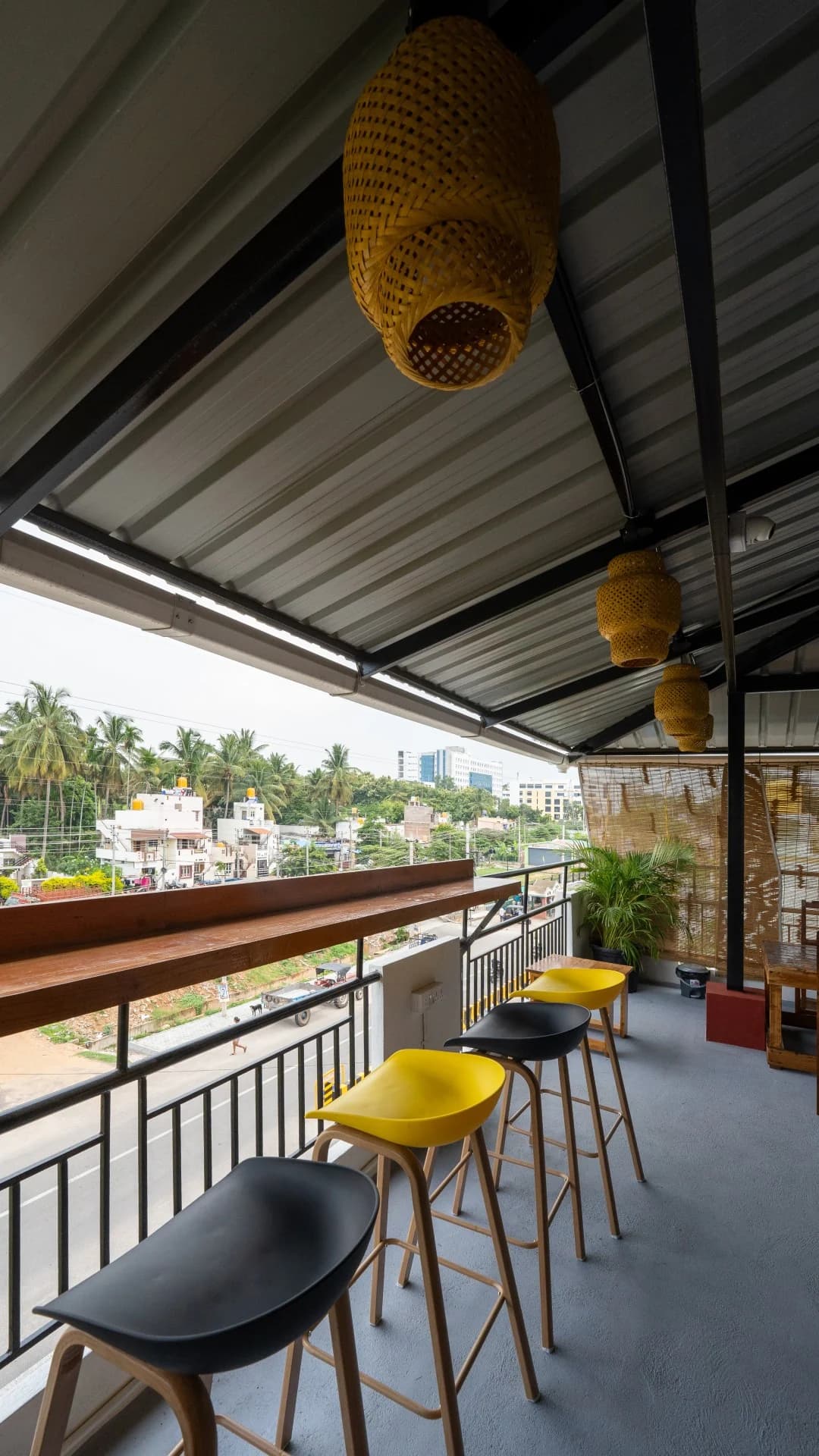 Bar stools overlooking the neighbourhood from Trippr Mysuru’s rooftop